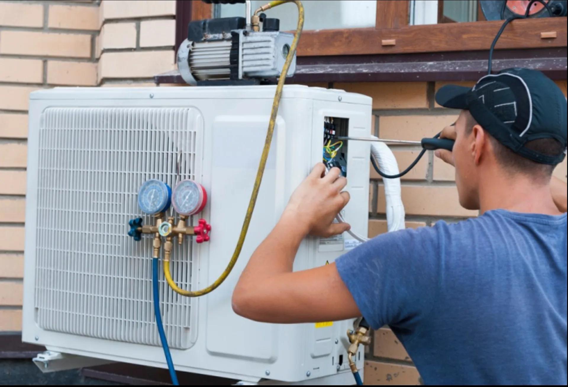 HVAC technician servicing an outdoor heat pump system